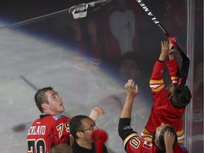 Calgary Flames forward Michael Ferland gives his stick to a fan after being named one of the stars of Game 3 on Sunday night.