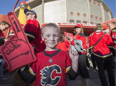 "Go Flames Go" says Mitchell Lambert, 4, as he joins the sea of red with his family outside the Saddledome before the Flames first playoff home game in six years in Calgary, on April 19, 2015.