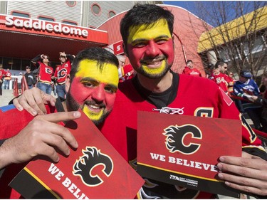 Nabi Attmad, left, and Qamar Attmad, who came all the way Grand Prairie, wait outside to be let into the Flames first playoff home game in six years at the Saddledome in Calgary, on April 19, 2015.