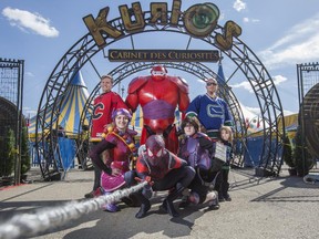 Calgary Flames fan Adam Gladowski poses in his Flames jersey with a curious bunch in front of the Cirque du Soleil tents. They are, clockwise from centre rear, Juan Gallardo dressed as Bay Max, Vancouver Canucks fan Nick Pearson and his son Lukas, Autumn Desjardins dressed as HIro, Devon Nippard as Spider-Man, and Emily Lassaline as Honey Lemon. Three iconic events collided on the Stampede grounds in Calgary, on April 19, 2015.