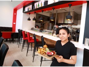 Shikha Seth holds one of Nu Burger Sushi Bar's bento boxes in the new downtown Calgary restaurant on Wednesday April 22, 2015.