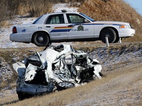 The mangled remains of a Toyota Prius lie in the ditch after a five vehicle crash that left one man dead on Highway 22 just north of the Trans Canada Highway on Wednesday, April 15, 2015.