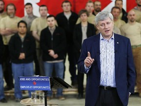 Prime Minister Stephen Harper speaks to supporters about a tax cut to small business included in the Economic Action Plan 2015 during a press conference at FC Woodworks Inc. in Winnipeg, April 23, 2015.