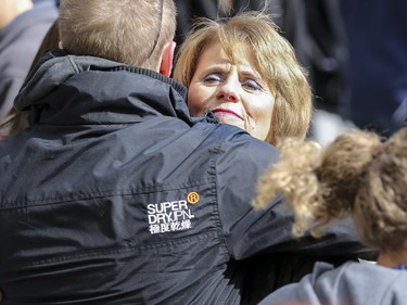 Irene Heffernan hugs her son Grant at the start of the rally organized by Cop Block Calgary in support of Anthony Heffernan and his family in Calgary, on April 4, 2015. Approximately 100 supporters came out to rally for Anthony Heffernan, who was killed in a police-involved shooting on March 16, 2015.