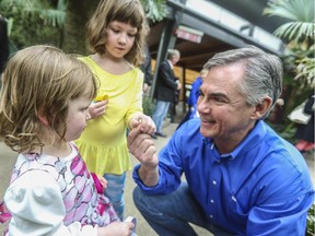 Premier Jim Prentice tried to pass an Easter egg to Paige Davis, 2,  but it was scooped up by her big sister Hannah, 6, Saturday at Calgary Zoo. Three days later, Prentice announced Albertans will go to the polls May 5.