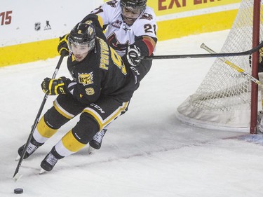 Calgary Hitmen's Terrell Draude chases down Brandon Wheat Kings' Ivan Provorov during WHL playoff action at the Saddledome in Calgary, on April 28, 2015.