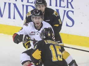Calgary Hitmen's Jake Bean readies himself to be sandwiched between Brandon Wheat Kings' Morgan Klimchuk and Peter Quenneville during Game 4 in their WHL Eastern Conference final series on Wednesday. The Wheaties won 8-3 to take a commanding 3-1 series lead back home to Brandon.