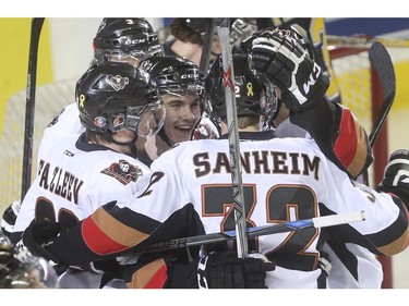 Calgary Hitmen's Jake Bean, centre, celebrates a goal with his team mates against the Brandon Wheat Kings during WHL playoff action at the Saddledome in Calgary, on April 29, 2015.