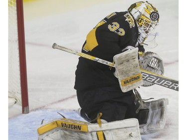 Brandon Wheat Kings' goalie Jordan Papirny makes the save off his helmet  during WHL playoff action against the Calgary Hitmen at the Saddledome in Calgary, on April 29, 2015.