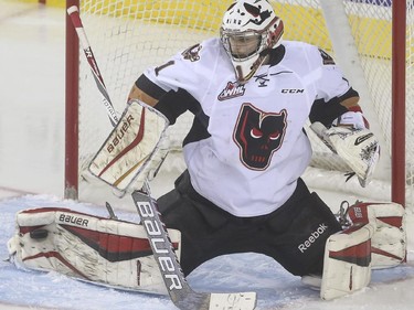 Calgary Hitmen's goalie Brendan Burke keeps this one out with his toe during WHL playoff action the Brandon Wheat Kings at the Saddledome in Calgary, on April 29, 2015.