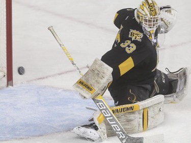Brandon Wheat Kings' goalie Jordan Papirny deflects the shot wide during WHL playoff action against the Calgary Hitmen at the Saddledome in Calgary, on April 29, 2015.