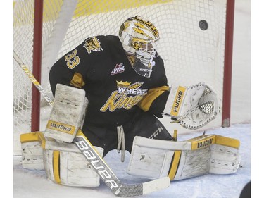 Brandon Wheat Kings' goalie Jordan Papirny can't keep this one out during WHL playoff action against the Calgary Hitmen at the Saddledome in Calgary, on April 29, 2015.