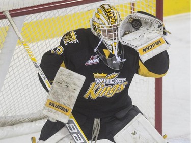 Brandon Wheat Kings' goalie Jordan Papirny shuts his eyes as he gloves a slap shot from the Calgary Hitmen during WHL playoff action at the Saddledome in Calgary, on April 28, 2015.