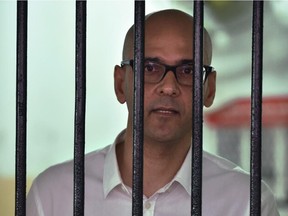 Canadian school administrator Neil Bantleman stands in a court detention cell in Jakarta shortly before his court appearance to face a verdict on April 2, 2015.