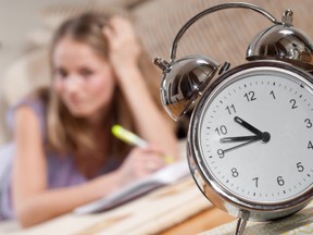 Young blonde woman is studying at home