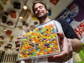 Matthew Hawes holds a container of jelly beans at Gummi Boutique in Kensington.