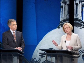 Alberta Progressive Conservative leader Jim Prentice listens to NDP leader Rachel Notley speak during the leaders debate in Edmonton on April 23, 2015.