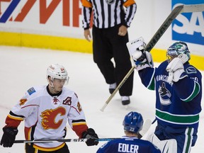 Calgary Flames' Jiri Hudler, left, skates away as Vancouver Canucks' goalie Ryan Miller celebrates after the Canucks defeated the Flames 2-1 during Game 5 on Thursday night.