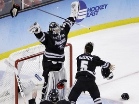 Providence goalie Jon Gillies raises his arms as he celebrates with teammates the Friars beat Boston University 4-3 for the NCAA Frozen Four championship last Saturday. Now he's with the Calgary Flames after signing his first pro contract.