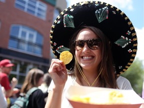 Nicque Winstanley enjoys some chips and salsa during the Sun and Salsa Festival in Calgary on July 20, 2014.