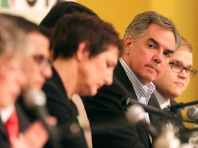 Colleen De Neve/ Calgary Herald CALGARY, AB --APRIL 18, 2015 -- Premier Jim Prentice leaned in to listen as Green Party leader and opponent Janet Keeping made her opening remarks while they took part in an all-candidates debate for their riding of Calgary-Foothills on April 18, 2015. (Colleen De Neve/Calgary Herald) (For City story by Trevor Howell) 00064310A SLUG: 0420-Foothills Debate