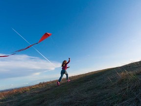 A young Calgarian flies a kite in Nose Hill Park.