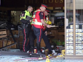Police examine the scene of a smash and grab at a Liquor Depot in Ogden.