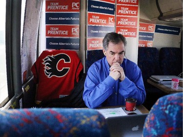 Premier Jim Prentice listened to a phone call while riding on his campaign bus en route to a campaign stop in Redcliff, AB. on April 16, 2015.