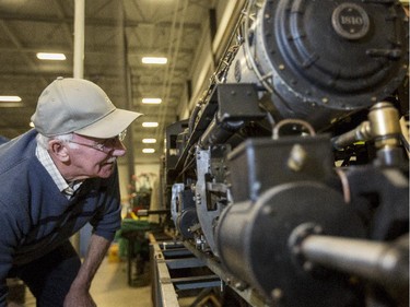 Brian Tonner examines the brake system on fellow Alberta Model Engineering Society member Eric Mortis's G.N. 2-6-6-2 Mallet at the during the set up of Supertrain 2015 at the Genesis Centre in Calgary, on April 17, 2015.