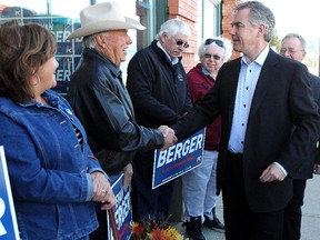 Premier Jim Prentice  shakes hands with Don WIlliams while making a stop in the Livingstone-Macleod area with PC candidate Evan Berger on Saturday, April 11, 2015. They stopped to open Berger's new office in Claresholm.