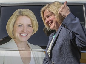 Rachel Notley gives the thumbs up next to the image of herself on her campaign vehicle after the NDP rally in Calgary, on April 8, 2015. -