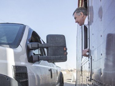 Premier Jim Prentice surprises a customer as he serves coffee from a take-out window at a Tim Hortons during his campaign tour stop in Red Deer, on April 9, 2015.