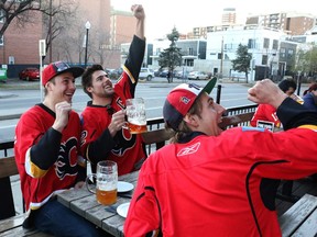 Jake Nagger, Brendon Skingle and Zach Nagger  cheer for the Flames at the National. Reader wants night-time celebrations on the Red Mile toned down.