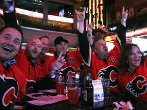 The Calgary Flames game against the Vancouver Canucks has Joseph Loria, Aaron Fortinski, Jordan Wanner, Ryan McKay, Kevin Hoekstra and Alana Turcotte celebrate at Flames Central on April 15, 2015.