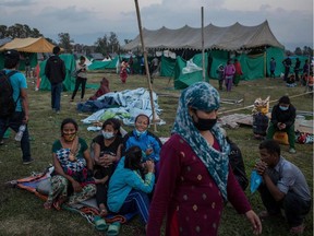 People wait to be allocated a new tent at the temporary camp for earthquake evacuees at Tundikhel Park on April 30, 2015 in Kathmandu, Nepal.