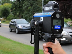 File phot: Police use photo radar to monitor motorists in a playground zone on 8th Avenue S.W., next to Earl Grey Elementary School. Reader would welcome more policing of residential areas and playground zones.