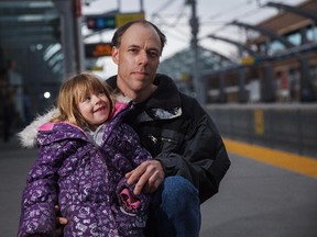 Rhett Brown and his six-year-old daughter, Trinity, stand at the 45th St. LRT station in Calgary on Friday, April 3, 2015.  Trinity fell onto the tracks while on her bike, and her dad jumped in to save her - both escaped unscathed.