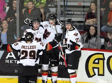CALGARY, ; APRIL 12, 2015  -- The Hitmen celebrate their first goal, Radel Fazleev, 29, Connor Rankin, 26, Travis Sanheim, 32 and  Ben Thomas, 27 in period two, game two as the Calgary Hitmen played host to the Medicine Hat Tigers at the Saddledome on April 12, 2015. (Lorraine HJalte/Calgary Herald) For Sports story by . Trax # 00064111A