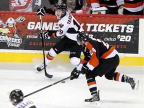 Calgary Hitmen forward Adam Tambellini battles Medicine Hat's Alex Mowbray during Game 2 of the series on April 12. He missed Game 4 in Medicine Hat but could return for Friday's Game 5.