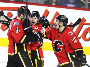 Calgary Flames centre Sam Bennett, centre, celebrated with teammates centre Joe Colbourne, left, and centre Mikael Backlund after scoring against the Vancouver Canucks during third period NHL Game 3 playoff action at the Scotiabank Saddledome in Calgary on April 19, 2015. The Flames defeated the Canucks 4-2 to take a 2-1 lead in the best-of-seven series.