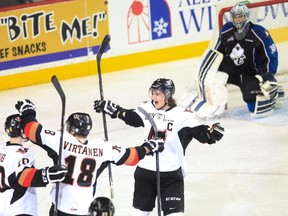 Calgary Hitmen captain Kenton Helgesen celebrates another goal as Kootenay Ice goalie Wyatt Hoflin looks on in Game 7 at the Scotiabank Saddledome. The Hitmen won 6-2 to eliminate the Ice 4-3.