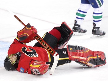 Calgary Flames goalie Jonas Hiller laid on the ice in pain after being hit by Vancouver Canucks Yannick Weber during third period NHL Game 3 playoff action at the Scotiabank Saddledome in Calgary on April 19, 2015. The Flames defeated the Canucks 4-2 to take a 2-1 lead in the best-of-seven series.