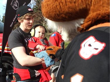 Flames hockey fans Phil Gillies and his 8-month-old son Lucas met Hitmen mascot Farley as they got geared up for Game 4 of the playoffs between the Calgary Flames and the Vancouver Canucks at the Scotiabank Saddledome on April 21, 2015.