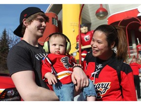 Flames hockey fans Phil Gillies, his wife Cat Gillies and their 8-month-old son Lucas got geared up for Game 4 of the playoffs between the Calgary Flames and the Vancouver Canucks at the Scotiabank Saddledome on April 21, 2015.