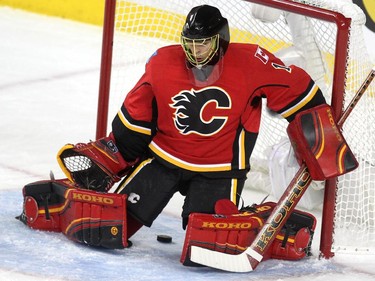 Calgary Flames goalie Jonas Hiller watched as the puck slid through his legs on a shot by Vancouver Canucks centre Henrik Sedin during first period NHL playoff action in game 4 of the series at the Scotiabank Saddledome in Calgary on April 21, 2015.