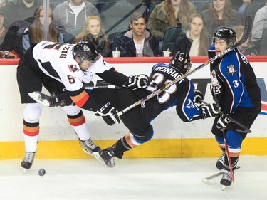 Kootenay Ice player Sam Reinhart falls in a scuffle with Calgary Hitmen player Keegan Kanzig at the Saddledome  in Calgary on Monday, April 6, 2015.