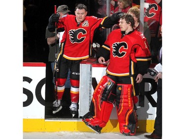 Calgary Flames centre and first star Jiri Hudler reached over to rub the head of goalie and second star Jonas Hiller after they defeated the Vancouver Canucks in NHL playoff action in game 4 of the series at the Scotiabank Saddledome in Calgary on April 21, 2015. The Flames defeated the Canucks 3-1 to take a 3-1 lead in the best of 7 series.