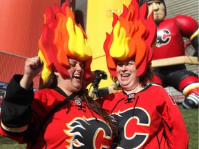 Calgary hockey fans Tania Stephenson, left, and Shauna Roth showed off their playoff hockey fashion outside the Scotiabank Saddledome prior to game 4 of the playoffs between Calgary and Vancouver.