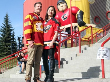 Colleen De Neve/ Calgary Herald CALGARY, AB --APRIL 22, 2015 -- Calgary hockey fans Matt Thompson and his friend Karen Dao showed off their playoff hockey fashion outside the Scotiabank Saddledome on April 21, 2015 prior to game 4 of the playoffs between Calgary and Vancouver. Dao chose to be fashionable adorning her hockey jersey with pleather pants and leather boots while McKenzie sported a Heritage Classic jersey. (Colleen De Neve/Calgary Herald) (For City story by Val Fortney) 00064508A SLUG: 0422-Flames Fans Fashion