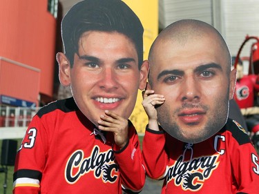 Calgary hockey fans Andrew Wytsma, left, and Gordon Penny showed off their playoff hockey fashion outside the Scotiabank Saddledome on April 21, 2015 prior to game 4 of the playoffs between Calgary and Vancouver. The two friends held oversized cardboard cutouts of Sean Monahan and Mark Giordano which has been a hot rage this playoffs.
